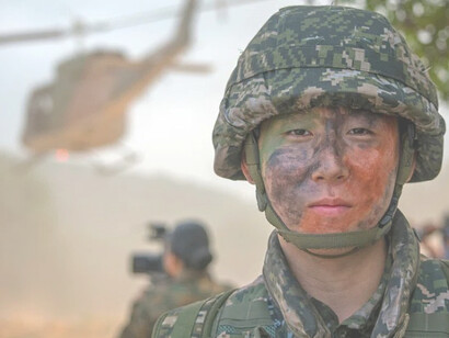 A uniformed North Korean soldier standing at attention