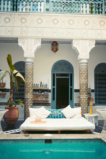 The white and blue swimming pool of a Marrakech riad, framed by enclosed courtyard architecture in Marrakesh–Safi, Morocco