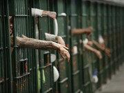 Men locked up in jail; many jails all over the world are packed and full of criminals