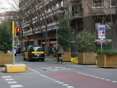 A smart city street in Barcelona, Spain, showcasing a dedicated bike lane and advanced traffic management systems