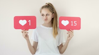 A girl posing with digital “like” symbols, illustrating online validation
