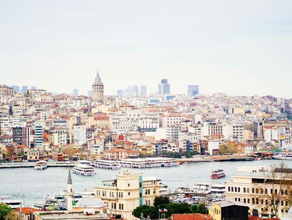 The Galata tower in the far left of the background stands tall in the city of Istanbul, Turkey
