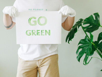 A person holding a go green sign
