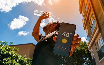 A man cools down with water as temperatures reach 40 degrees Celsius