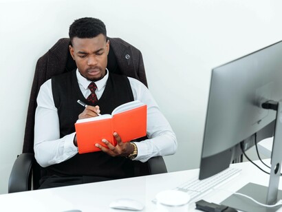 A business student reading his notes from the university lecture