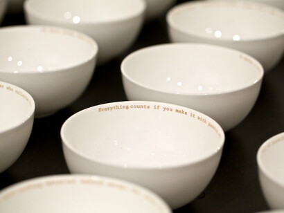 Claire Twomey, Everyman’s Dream (detail), 2013, bone china and 18 carat gold text. Installation view, Legacy at Crafts Council fair Collect at Saatchi Gallery © Sophie Mutevelian
