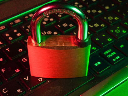 A striking padlock atop a sleek black computer keyboard serves as a powerful symbol of cybersecurity