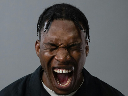 A young man screaming, mouth wide open