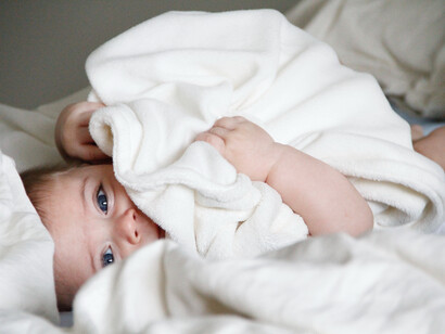 A baby lying on the bed
