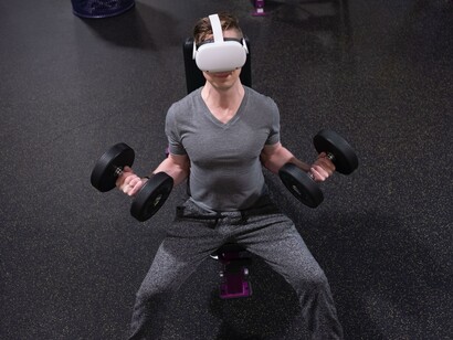 Wellness metaverse: man lifting dumbells with virtual reality gear