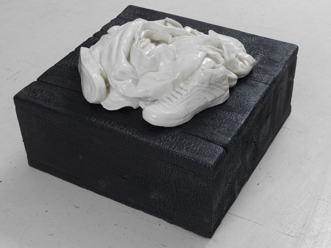 Reza Aramesh, Action 145: Friday April 25, 2003 at 07:55, 2015, Hand sculpted porcelain on charred wood plinth, 6 x 25 x 22 in. Photo by Brian Buckley