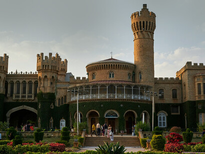The historic Bangalore Palace stands out for its grand stone architecture, ivy-covered walls, and distinctive towers, India