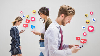 A group of people walking on the pavement, each absorbed in their phones, illustrating the addictive nature of social media