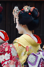 Women dressed in traditional Japanese attire: elegant kimonos with vibrant colors and intricate floral patterns are present in Japan's streets even nowadays