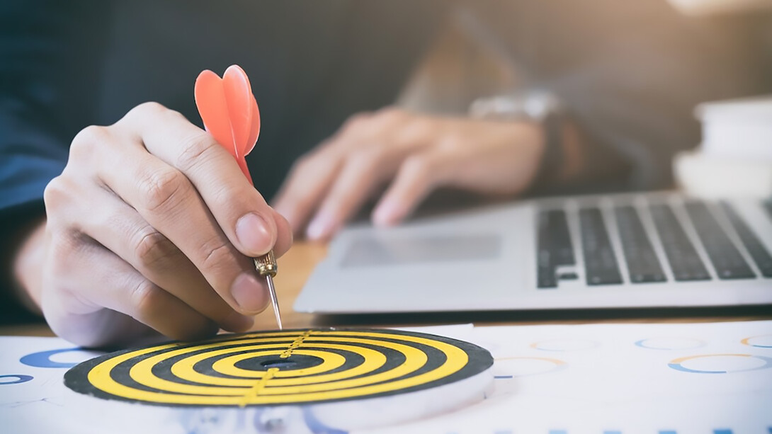 Business strategy success targets and goals illustrated on a dartboard