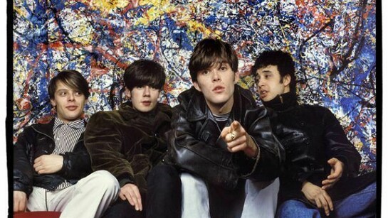 Ian Tilton’s first photoshoot of the band with new bassist Gary Mounfield, better known at Mani. Tilton: “They all turned up at my place together and had coordinated what they were wearing. Second hand clothes were the thing back then and they each wore heavy black, half-length overcoats; three were shiny leather and John’s was corduroy. Three of the band had grown sideburns (‘sidies’ or ‘diggers’ as we called them). March 29th, 1988.