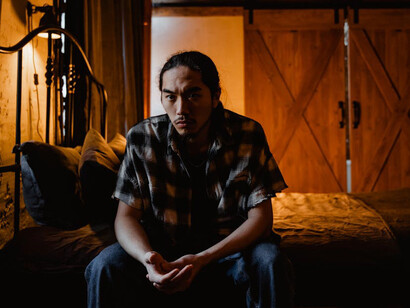 The empty space around him contrasts sharply with the digital noise he faces, highlighting the deep disconnect between online validation and real-life satisfaction