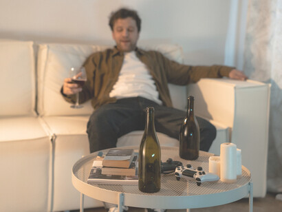 An alcoholic man drinking wine 