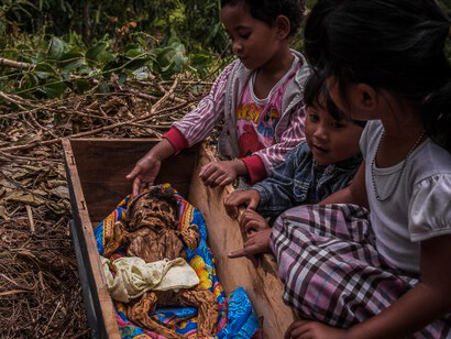 Coffins of infants and youngsters are hung from trees