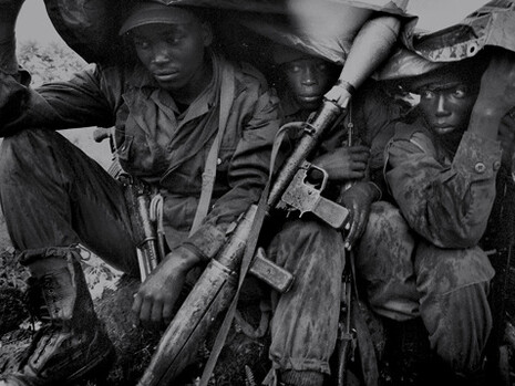 Democratic Republic of Congo yroops sheltering from the rain after a night of battle against rebel forces led by the warlord Laurent Nkunda, near Goma, eastern Congo, November 12, 2008
