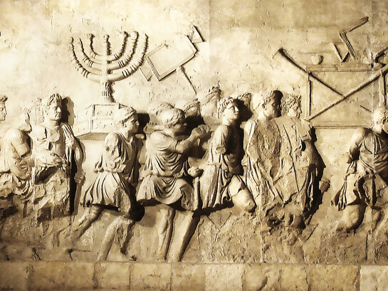 A relief on the Arch of Titus depicts Roman soldiers carrying treasures looted from the Jerusalem Temple, including the sacred menorah, during a triumphal procession following the conquest of Jerusalem in 70 CE