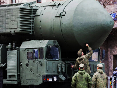 Russian military personnel near the Yars strategic missile launcher, designed to deliver nuclear payloads over long distances