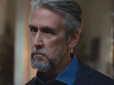 Connor Roy looking ahead with a serious expression, representing the isolation and emotional neglect he experienced as the eldest Roy child in Succession