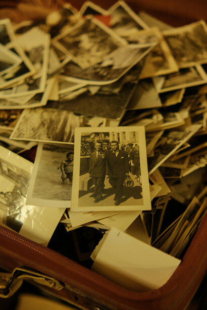 Vintage suitcase filled with old photographs
