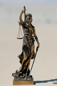 A Lady Justice statue, gracefully holding the scales of justice, symbolizing fairness and equity