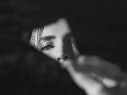 An eye reflected in a fractured mirror powerfully represents self-reflection and the journey of understanding one's role in relationships, prompting the question: "What is this teaching me about myself?"