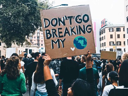 A sign carried by a person reads "don't go breaking my planet" is poignant since there are currently no other solutions than saving this one thus the need for climate action