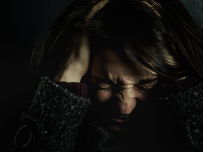 A young woman screaming, expressing feelings of anxiety