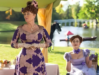 Lady Portia Featherington from Bridgerton wearing a richly patterned purple gown while accompanied by her daughter, symbolizing the extravagance of maximalist style