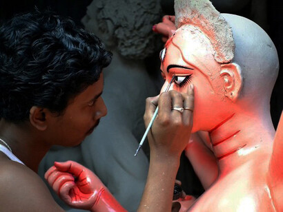 A painter of a Durga Puja statue