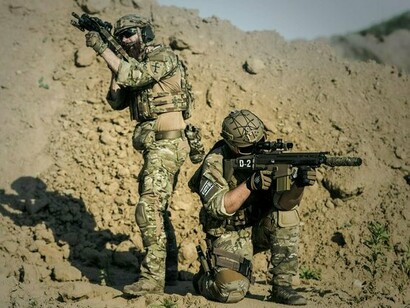 Armed military personnel standing alert and scanning the horizon, representing the heightened tensions of geopolitical conflict