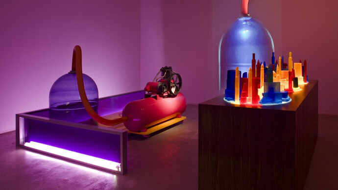 Mike Kelley, Kandor 4, 2007, Mixed media with video projection, Part 1 with bottle: 161.3 x 325.1 x 242.6 cm / 63 1/2 x 128 x 95 1/2 in, Part 2 with cities: 142.2 x 265.7 x 95.3 cm / 56 x 104 5/8 x 37 1/2 in, Overall dimensions variable, © Mike Kelley Foundation for the Arts.  All Rights Reserved/Licensed by VAGA, New York, Courtesy the artist and Hauser & Wirth, Photo: Fredrik Nilsen

