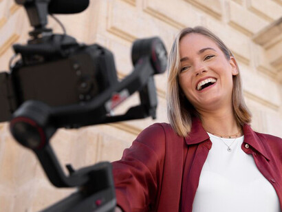 A female content creator capturing footage, representing the influence of women in media and their role in dismantling stereotypes in cinema