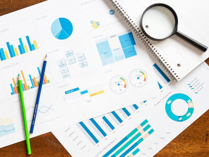 An overhead shot of various charts and infographics showcasing data visualization, digital marketing, and brand storytelling