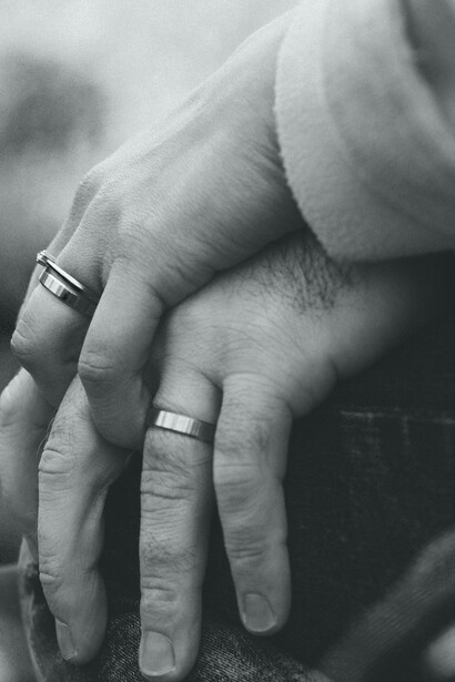 Married couple hold hands