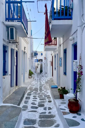 Once vibrant with life, the white and blue buildings of the Greek islands now tell a quiet story of empty homes and uncertain futures