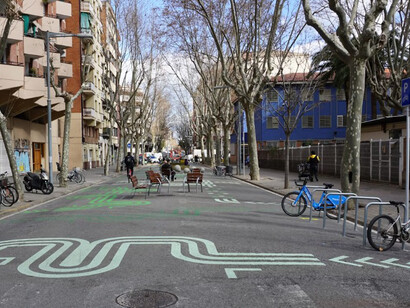 A city street in Barcelona, Spain, with a bike lane and integrated smart traffic management, highlighting the features of a smart city