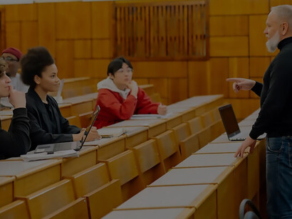 A lecture hall serves as the backdrop as a professor shares insights and knowledge with attentive students
