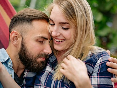 Close-up of a happy couple embracing on an outdoor hammock, radiating love, warmth, and affection