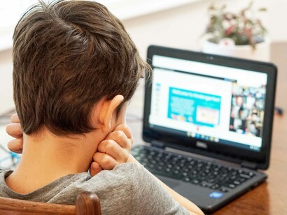 A bored young student feeling apathy toward education due in large part to the emergence of the new normal