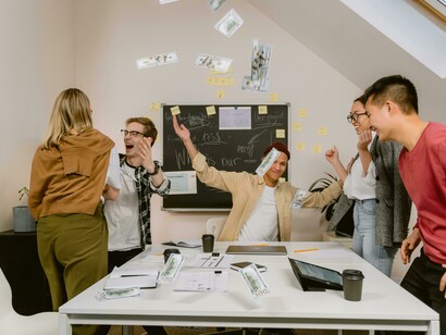 Young professionals gather in a meeting room to brainstorm, reflecting a diverse team culture, innovative teamwork, and creative problem-solving