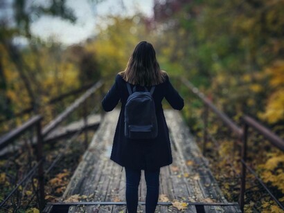 Traveling solo down a wooden path with a backpack is a journey that must be done at least once in your lifetime