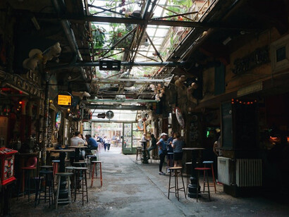 Patrons relish the ambiance inside a Budapest restaurant, immersing themselves in the city's culinary scene