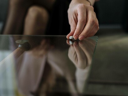 Placing the wedding band on the table as a sign that the marriage is over