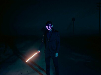 A masked individual symbolizes the hidden nature of cyberattacks