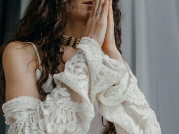 A serene woman practices meditation indoors, embracing mindfulness and wellness as part of her calm morning routine at home
